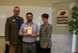 Abe Kruger receives the EarthCraft Design Award from Southface's Marci Reed and Robert Reed.